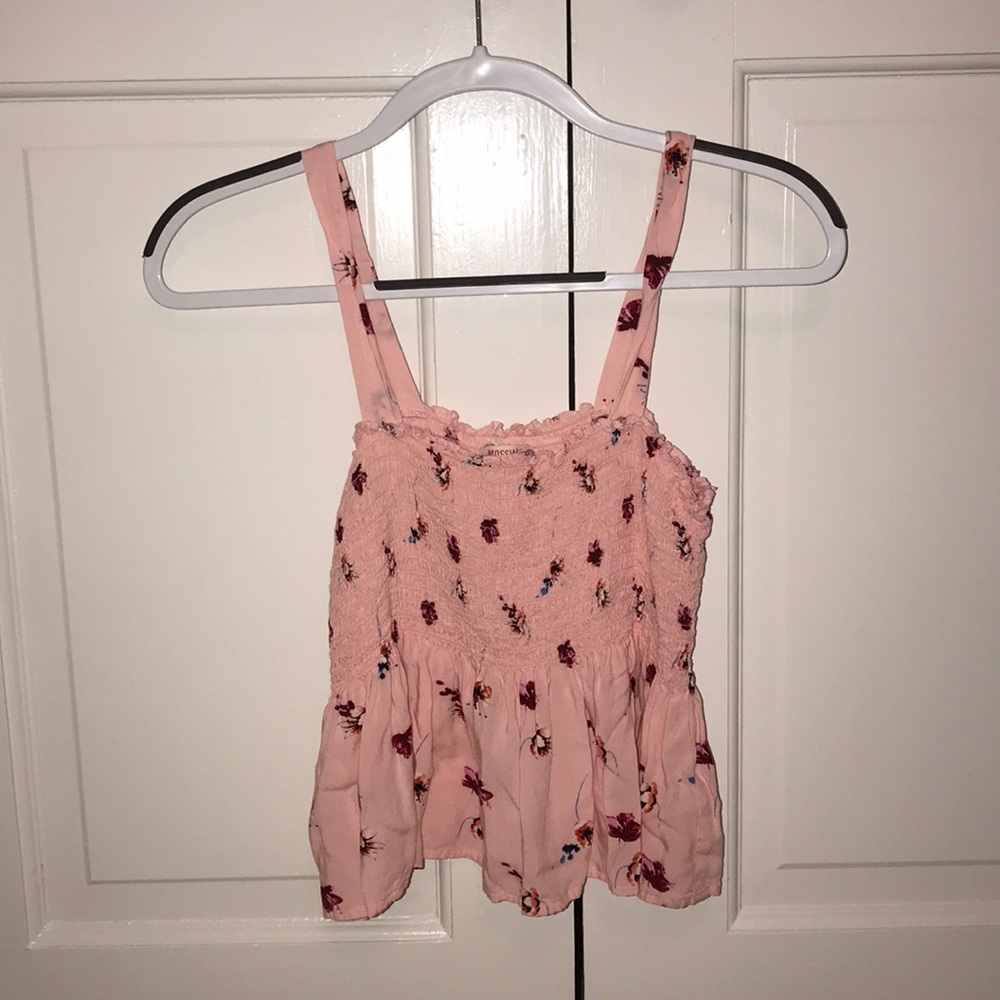 pink smocked top with flow at the bottom